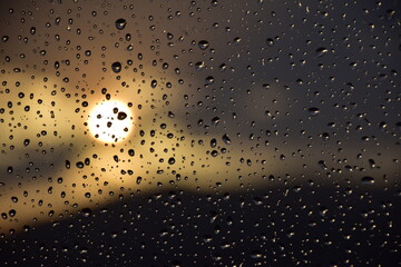 Rain drops on a windows in sunset time