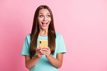 Photo of young attractive cheerful excited happy smiling woman using cellphone look copyspace isolated on pink color background