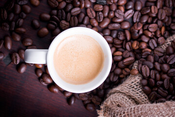 cup of coffee with beans and bag
