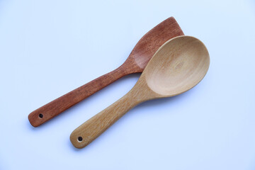Wooden spoons for kitchen appliances isolated on white background closeup. 