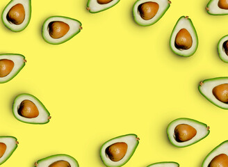 yellow bright background with laid out chaotically avocados with a place in the center under the text, copy space