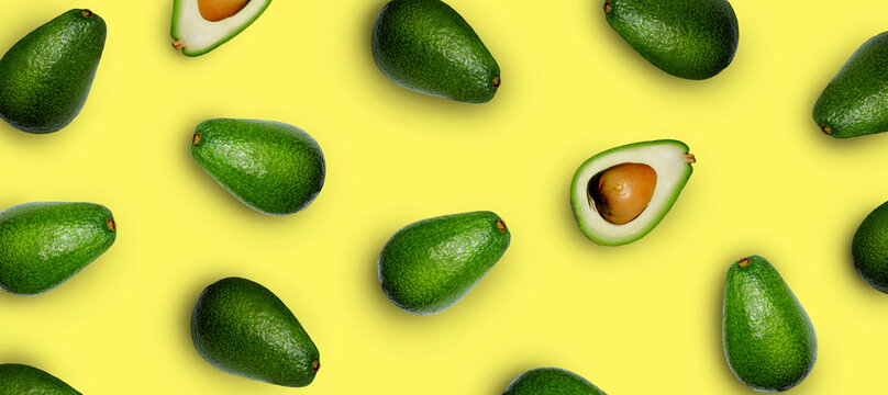 horizontal banner with avocado on a yellow background top view, copy space