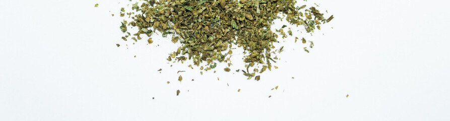 Ground buds of medical marijuana. Closeup on medical hemp blend isolated on white background. CBD,...