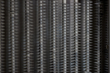 Threaded metal pipes, part of an industrial cooling system, close-up.