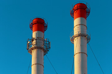 Chimneys of the power plant against the sky.
