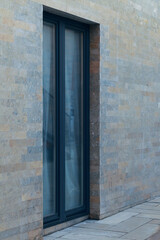 Narrow glass front door in an office building.