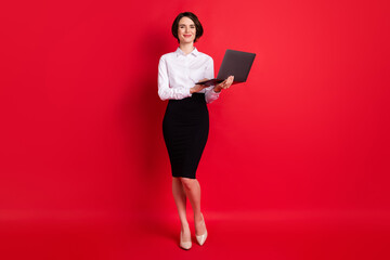 Full length body profile photo business woman keeping laptop smiling isolated vivid red color...