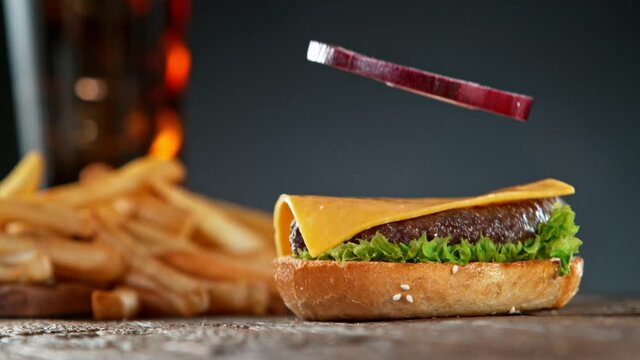 Super Slow Motion Shot of Falling and Stacking Parts of Cheeseburger at 1000fps.