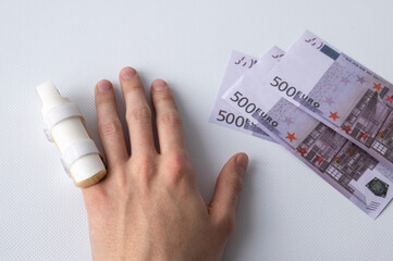 medical splint on a broken finger and money on a white background. Expensive medical services and insurance