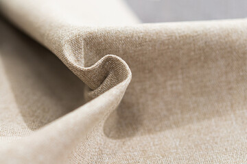 Fototapeta na wymiar Luxury beige fabric sample close-up. Can be used as background.