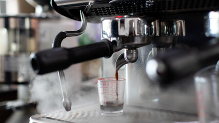 Close up photo of making coffee with machine in cafe. Professional modern espresso coffee machine...