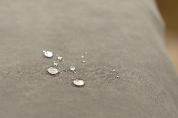 Fototapeta na wymiar Water drops on waterproof textile material - short depth of field.