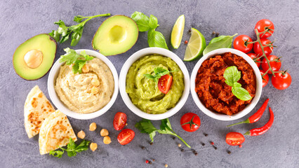 various hummus dips and pita bread