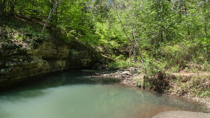 Fototapeta na wymiar Crack in the rock trail, Van Buren, Arkansas, mountain stream with blue green water