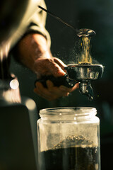 Fototapeta na wymiar Bairsta use spoon to fetch ground coffee prepare for making cup of coffee.
