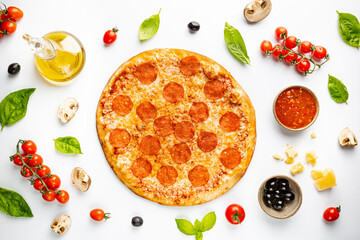 Tasty pepperoni pizza and cooking ingredients tomatoes basil on white background. Top view of hot pepperoni pizza.