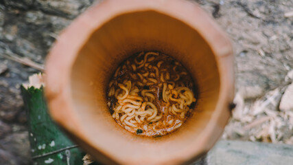 Boiled instant noodles with a bamboo barrel.