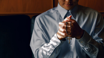 Close up cross. Asian Man praying for blessings to Jesus It is the confession of sins before God by...
