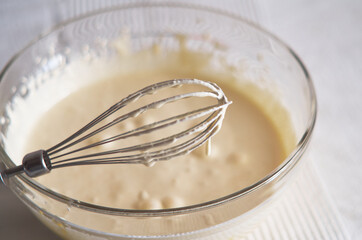 Whisk the cake mixture. Whisk in a bowl close-up