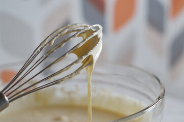 Whisk the cake mixture. Whisk in a bowl close-up