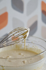 Whisk the cake mixture. Whisk in a bowl close-up