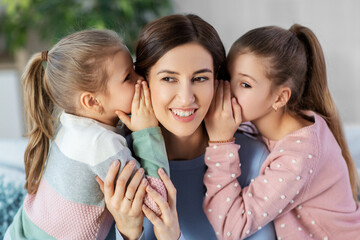 people, family and concept - happy mother and two daughters gossiping at home