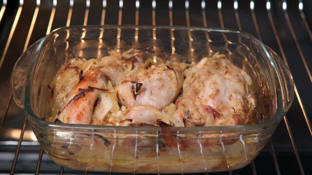 roasted Chicken over baking sheet in oven. Selective focus, close up view. Organic country food.