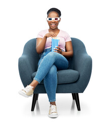 cinema and people concept - happy smiling african american woman in 3d movie glasses eating popcorn from striped bucket sitting in armchair over white background