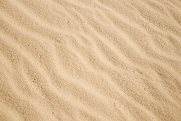 Sand pattern, beautiful orange sand by the sea, interesting abstract texture