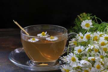 chamomile tea and flowers in a cup.