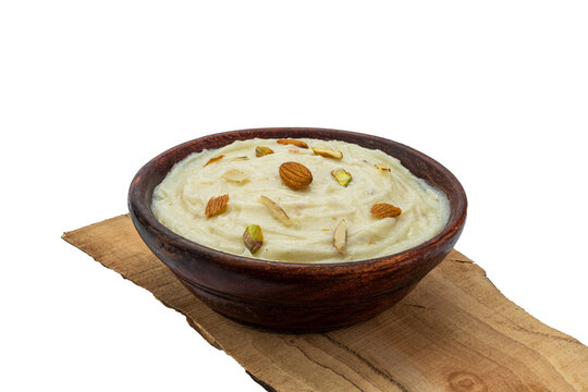 badam, kesar , pista shrikhand or amrakhand in a wooden bowl with food styling for food product packaging or social media 