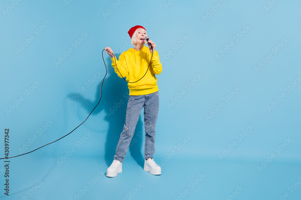 Poster Full length photo of cheerful nice happy old woman sung karaoke enjoy isolated on pastel blue color background