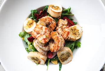 Salad with prawns, peppers, avocado, broccoli and arugula served from the restaurant menu