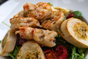 Salad with prawns, peppers, avocado, broccoli and arugula served from the restaurant menu