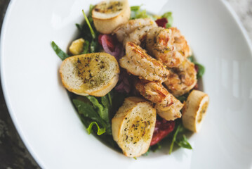 Salad with prawns, peppers, avocado, broccoli and arugula served from the restaurant menu