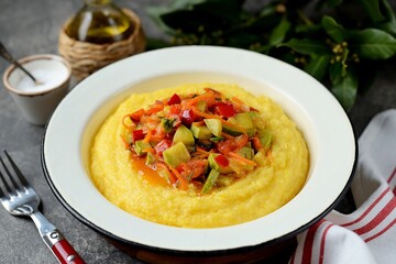 Corn porridge with stewed vegetables.