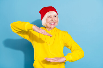 Photo of dreamy happy nice old woman look empty space dance funky isolated on pastel blue color background