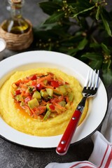 Corn porridge with stewed vegetables.
