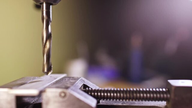Shot of a drilling machine rotation at the workplace of a toolman locksmith, UHD 4k macro video
