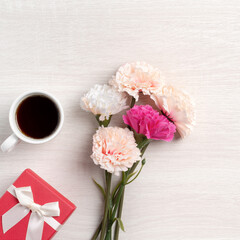 Mother's Day design concept. Top view of carnation flower and holiday gift idea.