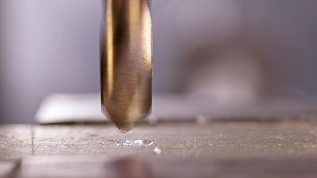 Shot of a drilling machine rotation at the workplace of a toolman locksmith, UHD 4k macro video