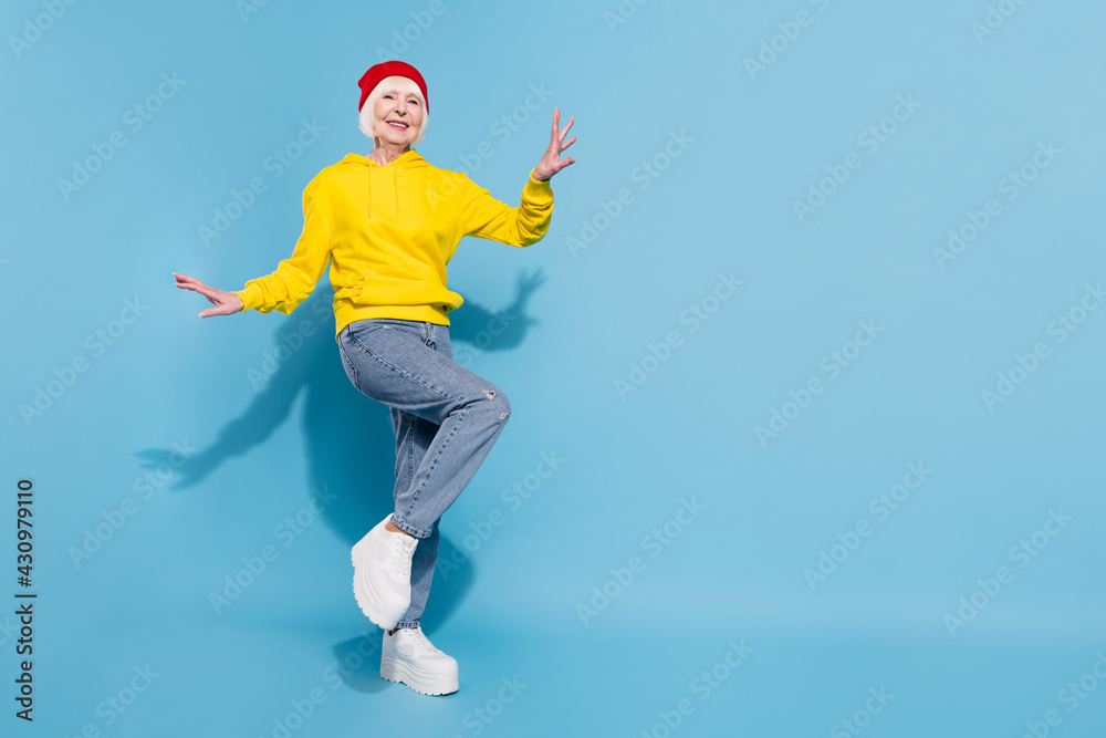 Sticker full body photo of attractive funky old woman wear hat dance good mood isolated on blue color backgr