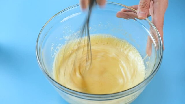 pastry chef use wire whisk mixing meringue egg for cake and bakery.