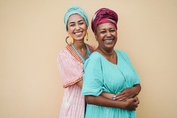 Happy african mother and daughter hugging each others - Mum day concept - Main focus on senior...
