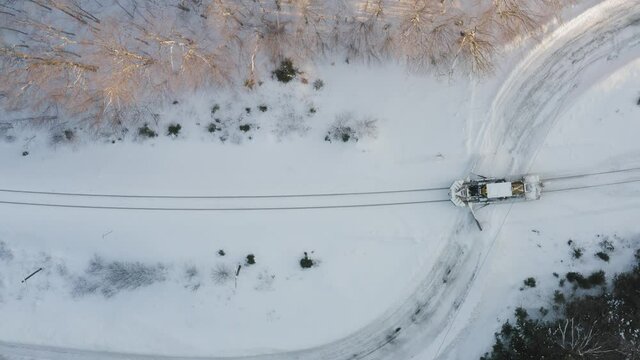 Snow plow on railway track top down aerial 4k 