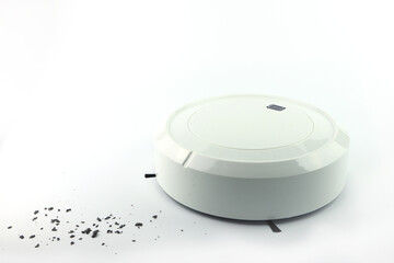 nice white modern automatic scan robotic vacuum is cleaning the dirty floor of the bedroom of a white home by itselft without the controlling