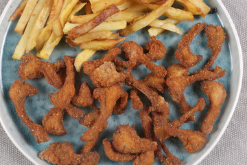 breaded rabbit ribs with fried potatoes