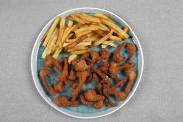 breaded rabbit ribs with fried potatoes