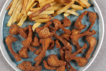 breaded rabbit ribs with fried potatoes