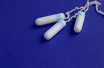 three female tampons lie on a bright background. Feminine hygiene products. Copy space. High quality photo